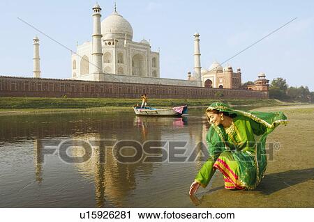 Young woman crouching on the riverbank, Taj Mahal, Agra, Uttar Pradesh, India View Large Photo Image Stock Image - Young woman crouching on the riverbank, Taj Mahal, Agra, Uttar Pradesh, India. Fotosearch
