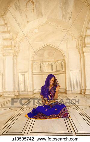 Young woman sitting on the floor and smiling View Large Photo Image Stock Image - Young woman sitting on the floor and smiling. Fotosearch