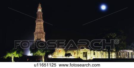 Stock Photography - Low angle view of a monument lit up at night, Qutub Minar, New Delhi, India. Fotosearch