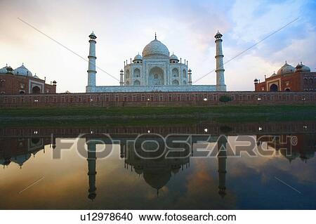 Stock Image - Reflection of a mausoleum in water, Taj Mahal, Agra, Uttar Pradesh, India. Fotosearch
