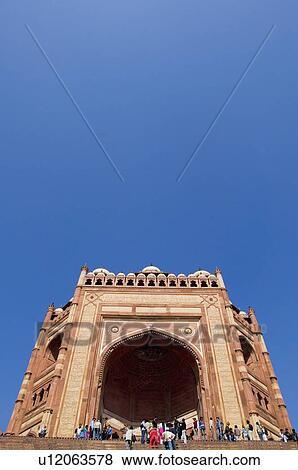 Stock Photo - Tourist standing in front of a building, Buland Darwaza, Fatehpur Sikri, Uttar Pradesh, India. Fotosearch