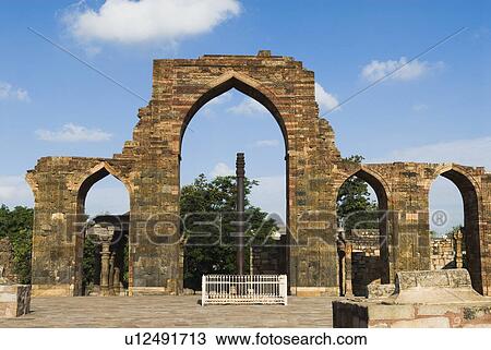 Stock Image - Iron pillar in the courtyard of a monument, Qutab Minar, New Delhi, India. Fotosearch