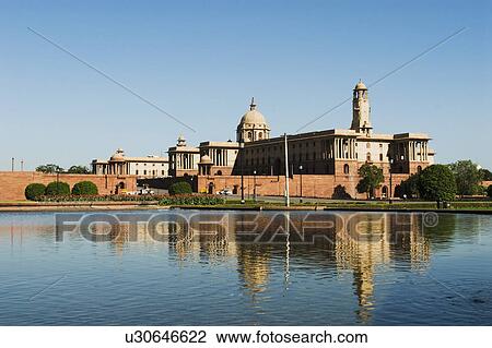 Stock Image - Reflection of a government building in water, Rashtrapati Bhavan, New Delhi, India. Fotosearch