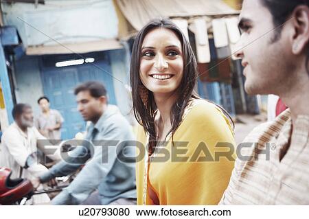 Stock Image - Close-up of a young couple smiling. Fotosearch