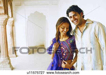 Stock Photo - Close-up of a young couple smiling. Fotosearch