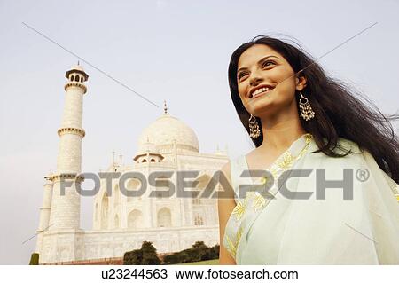 Close-up of a young woman standing in front of a mausoleum, Taj Mahal, Agra, Uttar Pradesh, India View Large Photo Image Stock Image - Close-up of a young woman standing in front of a mausoleum, Taj Mahal, Agra, Uttar Pradesh, India. Fotosearch