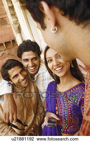 Close-up of three young men and a young woman smiling, Agra, Uttar Pradesh, India View Large Photo Image Stock Image - Close-up of three young men and a young woman smiling, Agra, Uttar Pradesh, India. Fotosearch