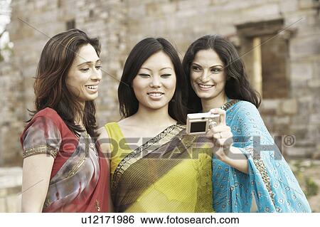 Close-up of three young women taking a photograph of themselves View Large Photo Image Stock Photograph - Close-up of three young women taking a photograph of themselves. Fotosearch