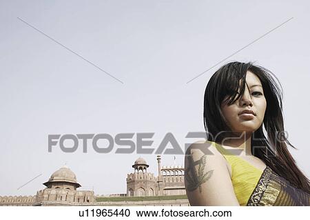 Low angle view of a young woman in front of a fort, Red Fort, Delhi, India View Large Photo Image Stock Image - Low angle view of a young woman in front of a fort, Red Fort, Delhi, India. Fotosearch