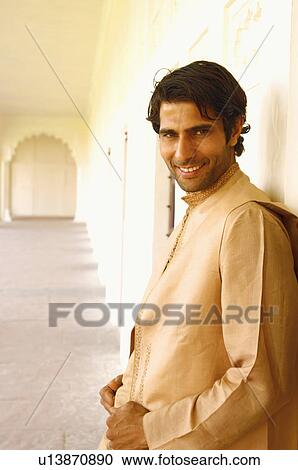 Portrait of a young man leaning against a wall and smiling View Large Photo Image Stock Image - Portrait of a young man leaning against a wall and smiling. Fotosearch