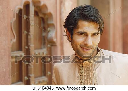 Stock Photography - Portrait of a young man smiling, Agra Fort, Agra, Uttar Pradesh, India. Fotosearch