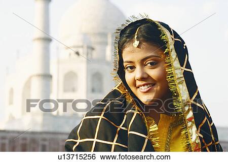 Portrait of a young woman smiling in front of a mausoleum, Taj Mahal, Agra, Uttar Pradesh, India View Large Photo Image Stock Photograph - Portrait of a young woman smiling in front of a mausoleum, Taj Mahal, Agra, Uttar Pradesh, India. Fotosearch