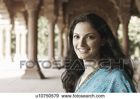 Portrait of a young woman smiling View Large Photo Image Stock Photo - Portrait of a young woman smiling. Fotosearch