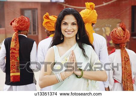 Portrait of a young woman standing in a prayer position View Large Photo Image Picture - Portrait of a young woman standing in a prayer position. Fotosearch