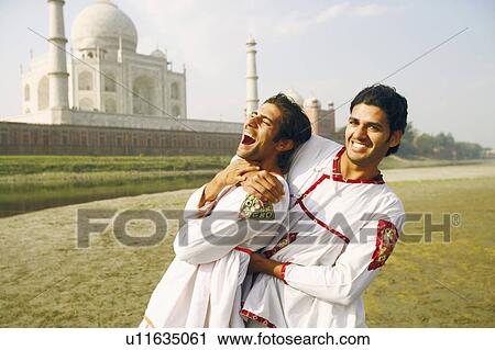 Portrait of two young men on the riverbank, Taj Mahal, Agra, Uttar Pradesh, India View Large Photo Image Stock Image - Portrait of two young men on the riverbank, Taj Mahal, Agra, Uttar Pradesh, India. Fotosearch