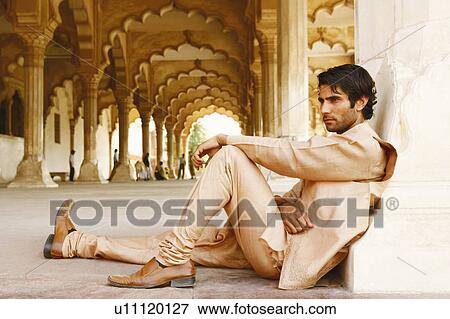 Side profile of a young man sitting on the floor, Agra Fort, Agra, Uttar Pradesh, India View Large Photo Image Stock Photo - Side profile of a young man sitting on the floor, Agra Fort, Agra, Uttar Pradesh, India. Fotosearch