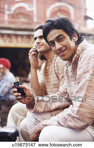 Stock Photo - Two young men sitting in a rickshaw. Fotosearch