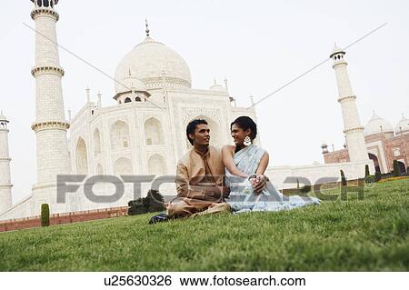 Young couple sitting in front of a mausoleum, Taj Mahal, Agra, Uttar Pradesh, India View Large Photo Image Stock Photograph - Young couple sitting in front of a mausoleum, Taj Mahal, Agra, Uttar Pradesh, India. Fotosearch