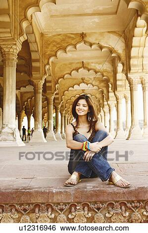 Young woman sitting on the floor and smiling, Agra Fort, Agra, Uttar Pradesh, India View Large Photo Image Stock Photograph - Young woman sitting on the floor and smiling, Agra Fort, Agra, Uttar Pradesh, India. Fotosearch