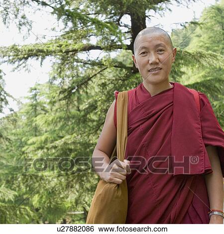 Close-up of a mid adult man smiling, McLeod Ganj, Dharmakot, Dharamshala, Himachal Pradesh, India View Large Photo Image Stock Photograph - Close-up of a mid adult man smiling, McLeod Ganj, Dharmakot, Dharamshala, Himachal Pradesh, India. Fotosearch