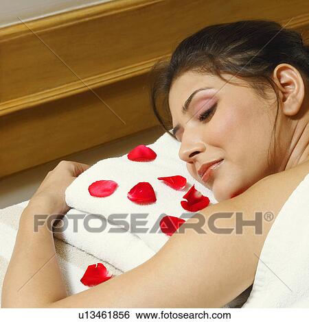 Close-up of a young woman lying on a massage table View Large Photo Image Stock Photograph - Close-up of a young woman lying on a massage table. Fotosearch
