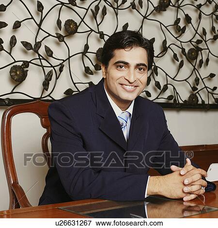 Portrait of a businessman smiling with his hands clasped View Large Photo Image Stock Photo - Portrait of a businessman smiling with his hands clasped. Fotosearch