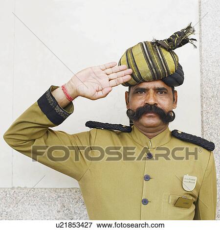 Stock Photo - Portrait of a security guard saluting. Fotosearch