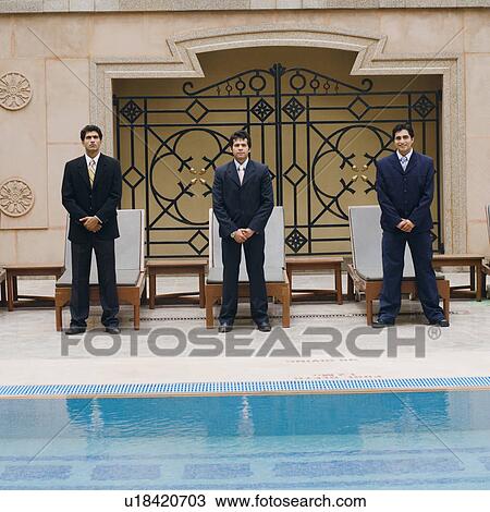 Portrait of three businessmen standing side by side near a swimming pool View Large Photo Image Stock Image - Portrait of three businessmen standing side by side near a swimming pool. Fotosearch