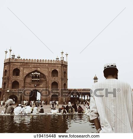 Rear view of a group of people sitting outside a mosque, Jama Masjid, New Delhi, India View Large Photo Image Stock Photo - Rear view of a group of people sitting outside a mosque, Jama Masjid, New Delhi, India. Fotosearch