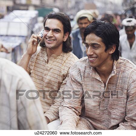 Two young men sitting in a rickshaw View Large Photo Image Stock Image - Two young men sitting in a rickshaw. Fotosearch