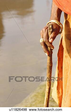 Stock Photo - Close-up of a person's hand holding a stick. Fotosearch