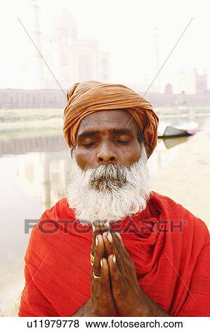 Close-up of a priest standing in a prayer position on the riverbank, Taj Mahal, Agra, Uttar Pradesh, India View Large Photo Image Stock Photo - Close-up of a priest standing in a prayer position on the riverbank, Taj Mahal, Agra, Uttar Pradesh, India. Fotosearch