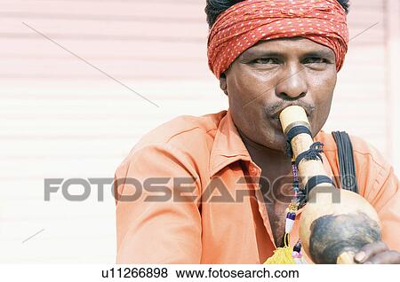 Close-up of a snake charmer playing a wind instrument, Jaipur, Rajasthan, India View Large Photo Image Stock Photo - Close-up of a snake charmer playing a wind instrument, Jaipur, Rajasthan, India. Fotosearch