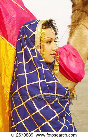 Stock Photo - Close-up of a young woman in traditional clothing. Fotosearch