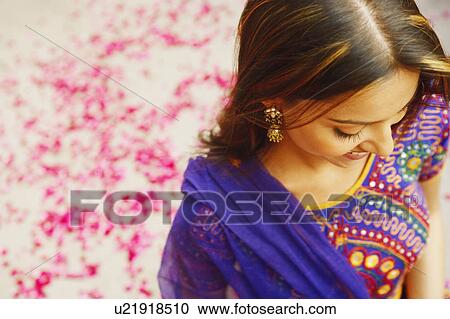 Stock Image - Close-up of a young woman looking down. Fotosearch
