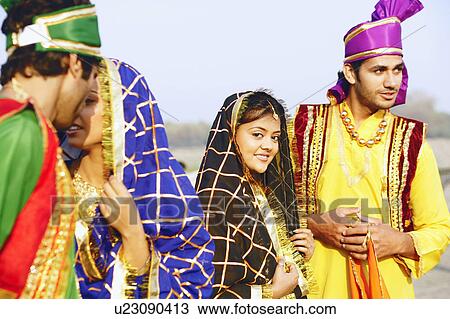 Stock Image - Close-up of two young couples smiling. Fotosearch