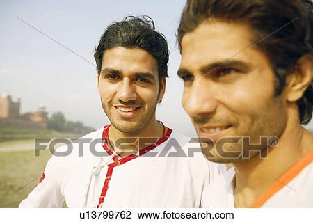 Close-up of two young men smiling together on the riverbank, Agra, Uttar Pradesh, India View Large Photo Image Stock Image - Close-up of two young men smiling together on the riverbank, Agra, Uttar Pradesh, India. Fotosearch