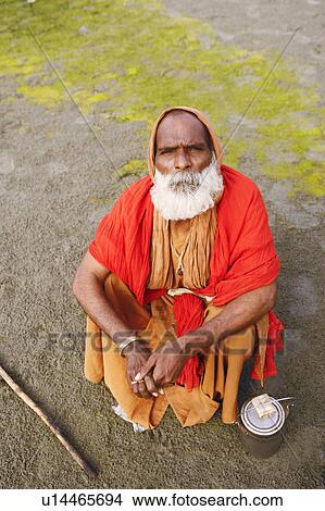 High angle view of a priest crouching on the riverbank, Agra, Uttar Pradesh, India View Large Photo Image Picture - High angle view of a priest crouching on the riverbank, Agra, Uttar Pradesh, India. Fotosearch