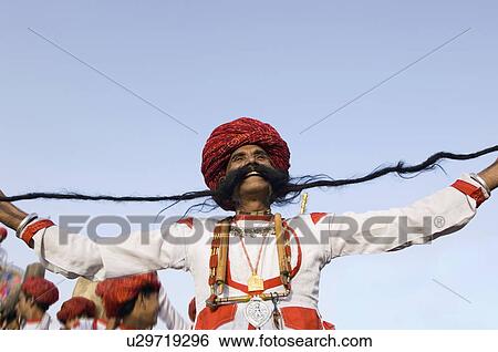 Low angle view of a mature man holding his mustache, Elephant Festival, Jaipur, Rajasthan, India View Large Photo Image Stock Photograph - Low angle view of a mature man holding his mustache, Elephant Festival, Jaipur, Rajasthan, India. Fotosearch