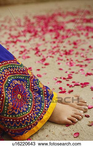 Low section view of a woman with rose petals scattered around her View Large Photo Image Stock Image - Low section view of a woman with rose petals scattered around her. Fotosearch