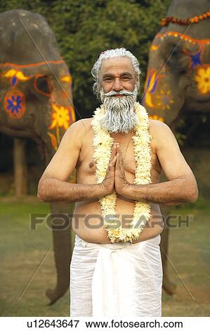 Stock Photo - Portrait of a priest greeting. Fotosearch