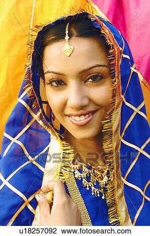 Stock Image - Portrait of a young woman smiling. Fotosearch