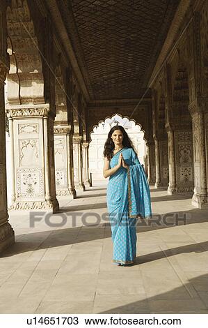 Portrait of a young woman standing in a prayer position View Large Photo Image Stock Image - Portrait of a young woman standing in a prayer position. Fotosearch