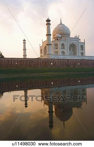 Stock Image - Reflection of a mausoleum in water, Taj Mahal, Agra, Uttar Pradesh, India. Fotosearch