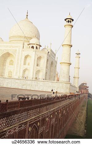Stock Photograph - Tourist walking on a walkway, Taj Mahal, Agra, Uttar Pradesh, India. Fotosearch