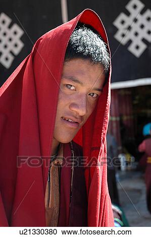 Close-up of a young man in a red shawl. View Large Photo Image Stock Image - Close-up of a young man in a red shawl.. Fotosearch