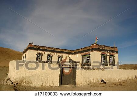 Stock Image - Front view of a rustic house in a remote place.. Fotosearch
