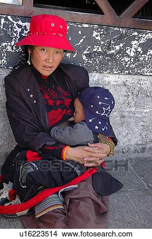 Picture - Portrait of a woman with a baby in arms.. Fotosearch
