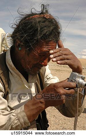 View of a poor man holding a camera. View Large Photo Image Picture - View of a poor man holding a camera.. Fotosearch