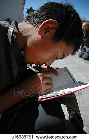 Stock Image - View of a young man writing.. Fotosearch